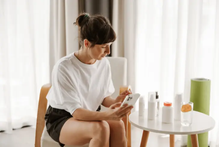 Woman scrolling social media for skincare